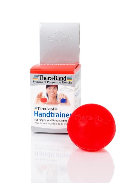 Theraband Ball in rot neben Verpackung